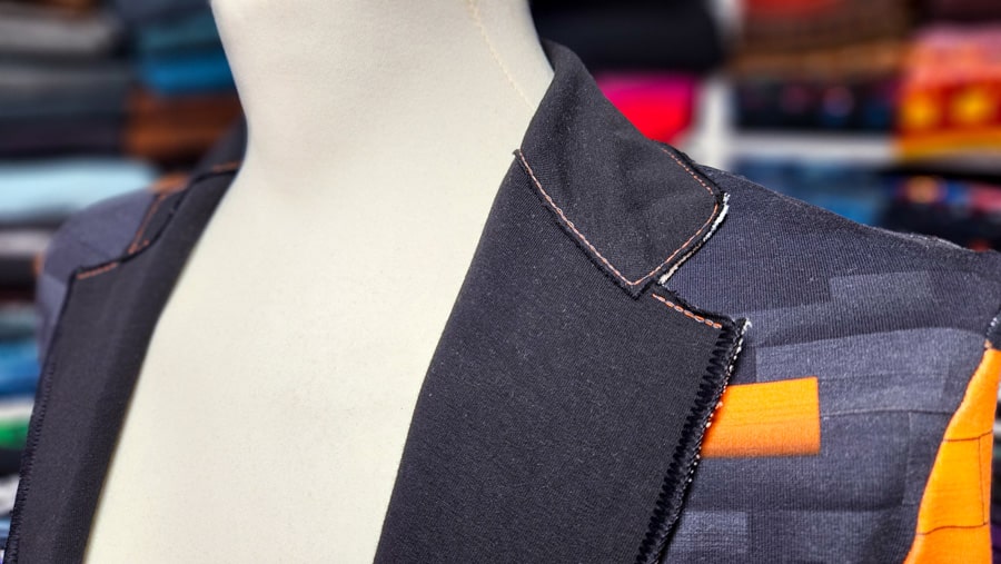 Detailansicht des Kragens eines fertigen Sweatshirt-Sakkos mit Kettstich und offenkantiger Verarbeitung.